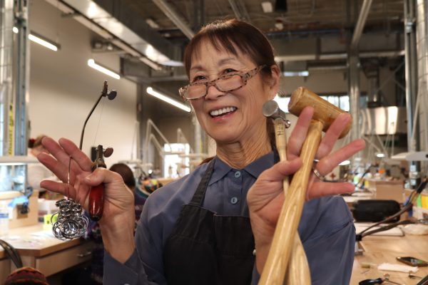 Professor Irene Mori enthusiastically poses with jewelry tools on Friday, March 29 at El Camino College. (Jamila Zaki | Warrior Life)