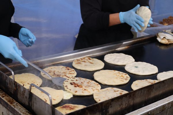 Two women prepare tortillas for waiting orders at their food vendor located on Crenshaw and Marine on Mar 30. (Miliana Cienfuegos | Warrior Life)