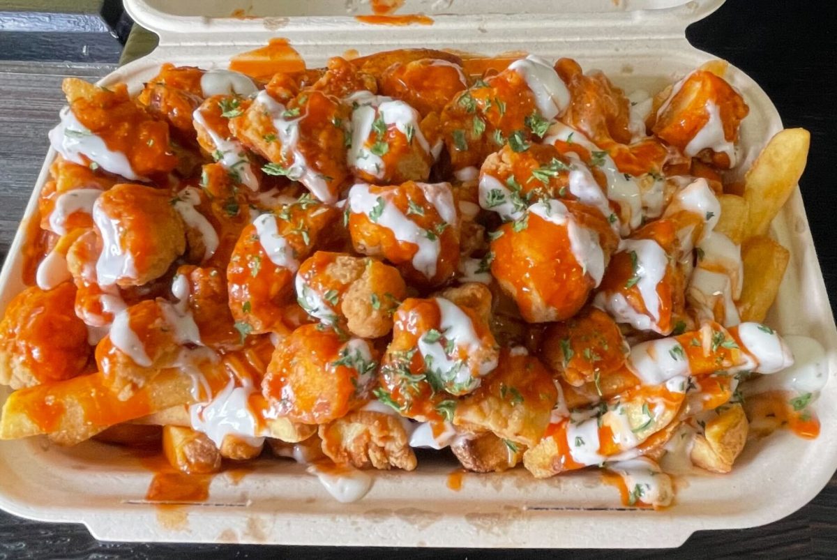 A regular size of Buffalo chicken ranch fries covered with chicken, buffalo sauce, a sizzle of ranch and green onions. (Jaylen Morgan | The Union)
