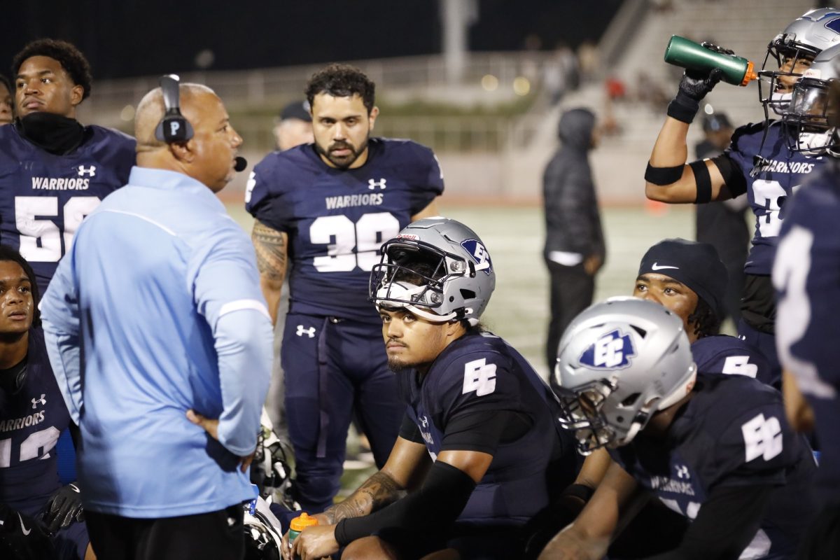 The El Camino Warriors defense sits on the sideline with defensive coordinator Matt Kirk during a Sept. 21 home game against the Riverside Tigers at Featherstone field. Riverside hammered El Camino 70-45. The Warriors look to bounce back on Sept. 28 to clash with Moorpark at 6 p.m. on the road. (Greg Fontanilla | The Union)