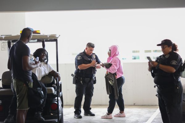 A woman involved in a physical altercation in Lot C is interviewed by an El Camino College Police Department officer on Thursday, Sept. 12 on the third floor of the parking lot where the physical altercation occurred. (Greg Fontanilla | The Union)