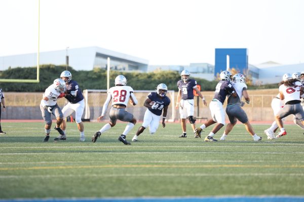 In its home opener on Saturday, Sept. 14 at Featherstone Field, Warriors running back Zamir Hall finds a hole in the Comets' defense for a gain of positive yardage. Hall rushed 20 times for 80 yards in a 14-10 loss to the Comets. Hall and the Comets will look to bounce back in a Sept. 21 clash against the Riverside Tigers at Featherstone Field at 6 p.m. (Greg Fontanilla | The Union)