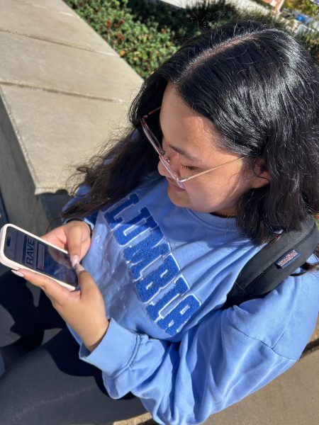 Katherine Cabrera, 18, a mathematics major, reads through a Rave digital flyer on her phone in front of the Student Services Building on Wednesday, Sept. 11. Cabrera, who normally attends classes during the day, said she feels safe on campus. "The police [officers] make me feel safe," Cabrera said. "[Rave] lets me know what&squot;s going on on-campus." (Greg Fontanilla | The Union)