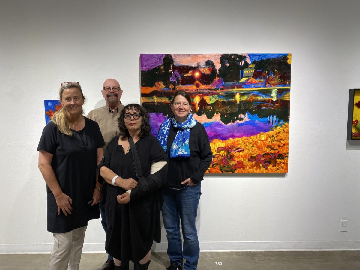 From left to right: Co-founder of ESMoA Eva Sweeney, Director of Gallery and Museum Programming Michael Miller, curator of XICANA! Dulce Stein and Director of Operations at ESMoA Barbara Boehm stand in front of Margaret Garcia's "Enchantment" oil painting. XICANA! opened to the public on Sept. 16 and will remain open until Dec. 14. (Katie Volk | The Union)