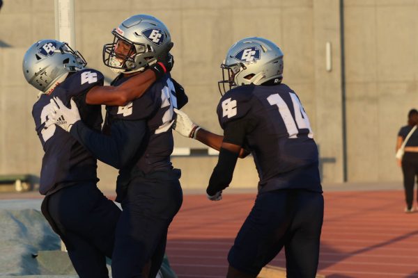 El Camino College Football team mates, (left) Elijah Holmes (3), Joshua Long (29), and Takim Raye-Brown Jr. (14) celebrating the first touchdown of the game. ECC scored their first touchdown on the first-and-ten. (Kayla Mitchell | The Union)