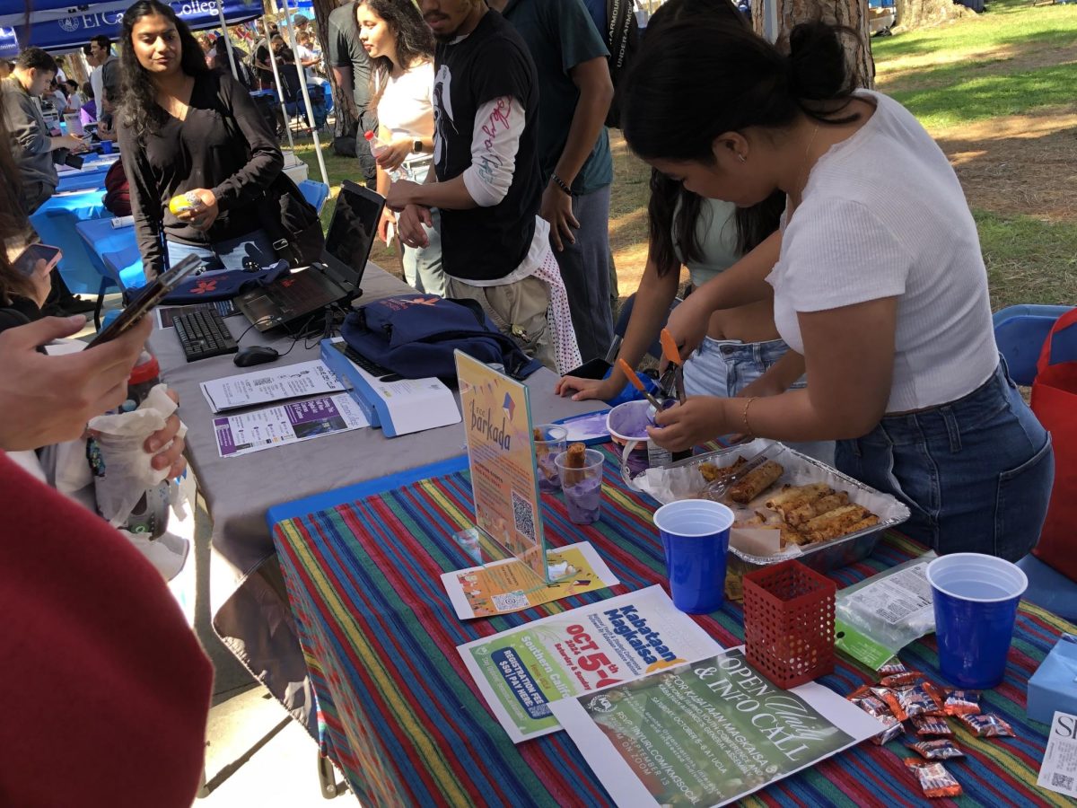 Representatives of Barkada, a club making its debut at El Camino College's campus serve Filipino food at a table during Club Rush on Wednesday, Sept. 11 on the Library Lawn. The three-day event began on Monday, Sept. 9, which showcased at least 50 clubs. Barkada welcomes students of all backgrounds to learn about Philippine culture and connect with each other. (Rhiannon Ellis | The Union)