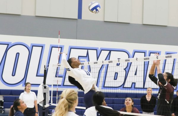 Aileron Scott middle blocker jumps high to spike the ball over the net. Renzo Arnazzi|The Union