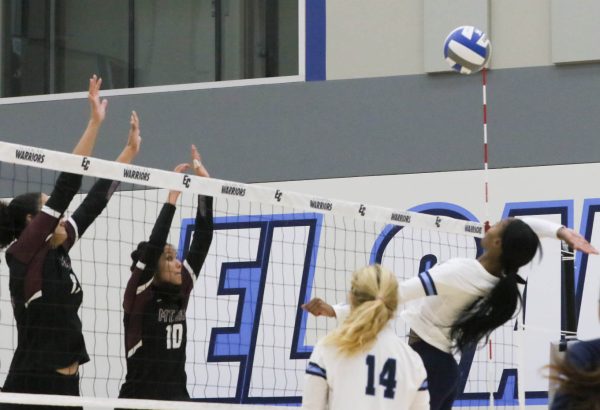 Warriors middle blocker Aireon Scott does a leaning backwards spike over the net as Mount Sac defenders meet at the opposite side of the net in hopes of blocking the spiked ball. 
Renzo Arnazzi| The Union