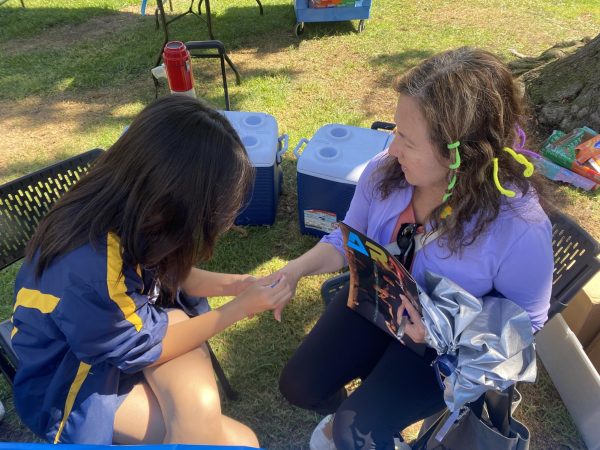 An Inter-club Council representative works at the painting booth during Club Rush, which took place at the Library Lawn on Wednesday, Sept. 11. Club Rush was a three-day event that showcased at least 50 clubs on campus. (Katie Volk | The Union)