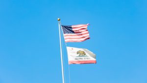 Flags representing the US and California fly on a pole in front of the Administration Building at El Camino College on Friday, Sept. 27. (Greg Fontanilla | The Union)