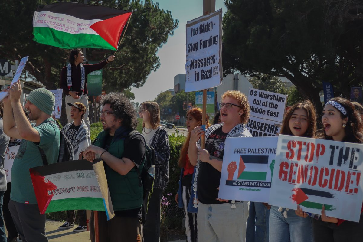 El Camino College students, faculty and other people not associated with the college protest the Israel-Hamas war on the corner of Manhattan Beach and Crenshaw Boulevard on Tuesday, Oct. 8. As the group protested on the corner street, some cars honked their horns in support while passing by. This was the second on-campus protest regarding the Israel-Hamas war since May 21, 2024. (Eddy Cermeno | The Union)