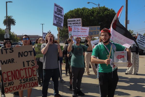 El Camino College students, faculty and other people not associated with the college protest the Israel-Hamas war on the corner of Manhattan Beach and Crenshaw Boulevards on Tuesday, Oct. 8. As the group protested on the corner street, some cars honked their horns in support while passing by. This was the second on-campus protest regarding the Israel-Hamas war since May, 21 2024. (Eddy Cermeno | The Union)