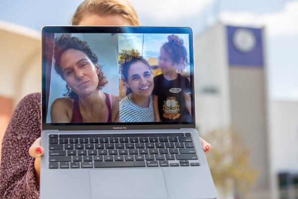 Sascha Recht, an Israeli American from Torrance now living in Haifa, Israel, holds up a computer showing photos ofher friends Carmel Gat (left) and Yarden Roman-Gat on Oct. 24, 2023 at El Camino College. Sisters-in-law Gat and Roman-Gat were captured by Hamas on Oct. 7. Roman-Gat was released on Nov. 29 and Gat was recently found dead in a tunnel in Gaza, among five other hostages that were killed by Hamas. (Raphael Richardson | The Union)