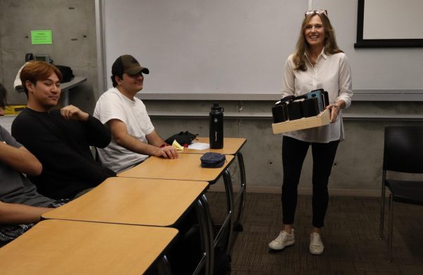 Professor Rose Cerofeci collects the phones of her English 1A students prior to class beginning on Sept. 30, 2024. Cerofeci instituted the "no phones" policy for her classroom to promote a better learning environment. (Erica Lee | The Union) Photo credit: Erica Lee