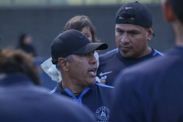 El Camino Warriors head coach Mike Jacobson, left, and assistant coach Miguel Sanchez, gather the team for a debrief after a final score of 1-1 against the Cerritos Falcons on the ECC Soccer Field on Tuesday, Oct. 29. In his five seasons with the ECC men’s soccer team, Jacobson has led the Warriors to the 3C2A SoCal Regional Playoffs four straight years, clenching the state championship in 2023. (Philip Mawamba | The Union)