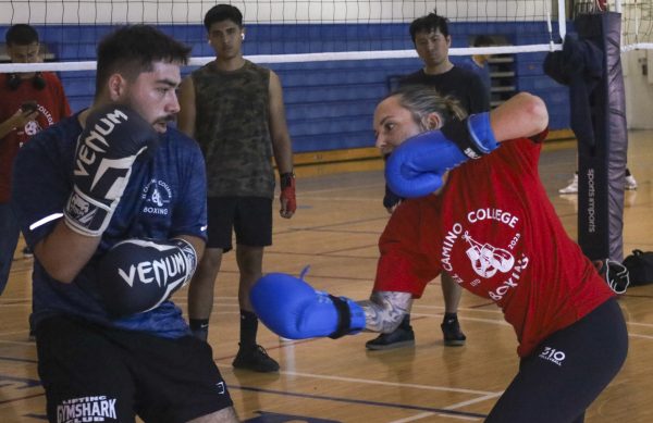 El Camino College Boxing Club president, from left, Alec Rodriguez and club advisor Rachel Pittock spar during the club's weekly meeting on Friday, Sept. 27, 2024. The club hosts their meetings every Friday from 10 a.m. to noon at the ECC South Gym. (Mario Trejos | The Union)