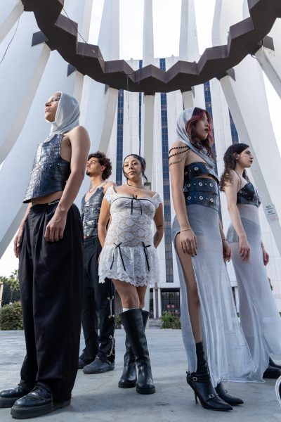 Ashley Mendoza, center, smiles as she stands with El Camino College student models wearing her “Medieval Summer” collection. The medieval armor-inspired ensemble won “Best Collection” in the fashion department’s spring fashion show on June 23. (Eddy Cermeno | Warrior Life)