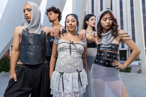 Ashley Mendoza, center, smiles as she stands with El Camino College student models wearing her “Medieval Summer” collection. The medieval armor-inspired ensemble won “Best Collection” in the Fashion Department’s spring fashion show on June 23. “It’s a collection inspired by my life what felt like going to war every day trying to survive all the adversities that I had to overcome,” Mendoza said. (Eddy Cermeno | Warrior Life)