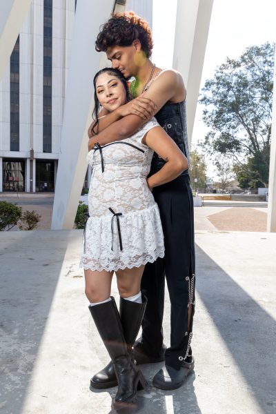 Antonio Guzman, 22, hugs his girlfriend Ashley Mendoza at the King Memorial in front of the Compton Courthouse on Oct. 27, 2024. Guzman is an El Camino and UCLA graduate with a bachelor’s degree in political science. Guzman and Mendoza met at El Camino and lived out of Mendoza’s car for eight months during the pandemic. (Eddy Cermeno | Warrior Life)