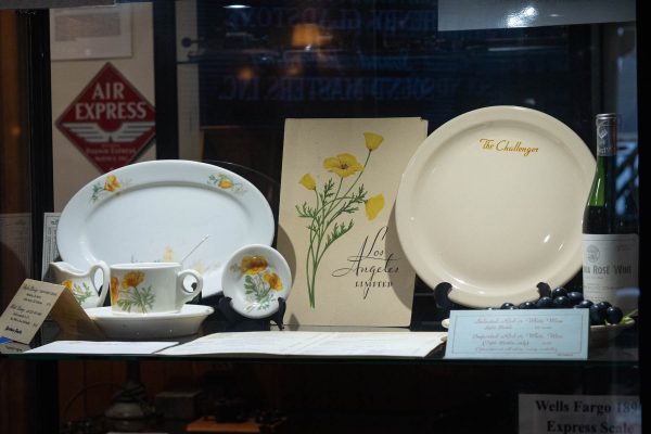 Display of custom dishware and menus at the Lomita Railroad Museum. The dishes were used for meals on The Los Angeles Limited train line and are decorated with California poppies and the train's name. (Katie Gronenthal | The Union)