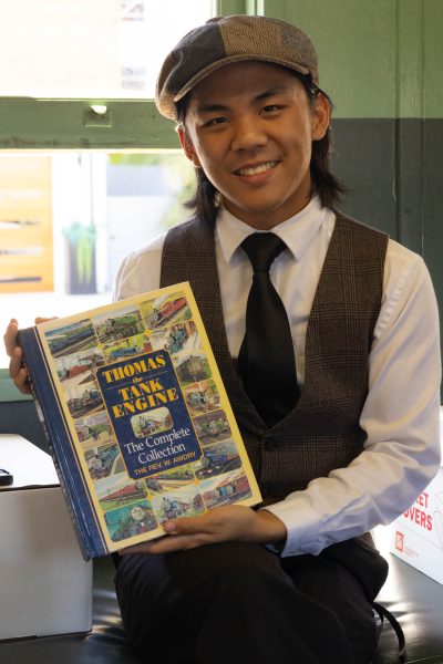 El Camino student Richard Jalandoni holds the Lomita Railroad Museum&squot;s copy of Thomas the Tank Engine: The Complete Collection in the Museum&squot;s Southern Pacific trainer/reading Library. Jalandoni credits the Thomas story "Stepney the &squot;Bluebell&squot; Engine" for starting his interest in steam trains. (Katie Gronenthal | The Union)