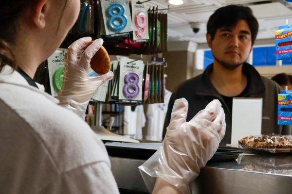 A Torrance Bakery sales associate helps a customer decide what cookies to order on Oct. 11. Torrance Bakery can sell up to 10,000 cookies a week.