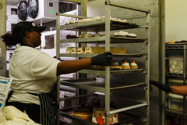 Torrance Bakery employee Ari Ward, 19, pushes a rack bearing cakes out of the walk-in fridge on Saturday, Oct. 11. Cakes are a top seller for the bakery, with anywhere between 400 to 500 cakes being sold per week.