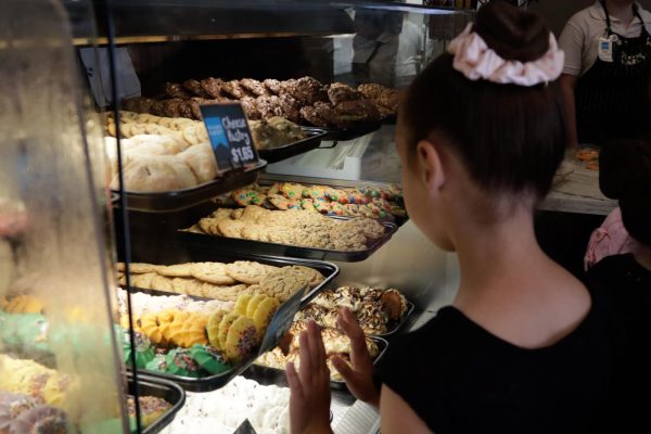 A young girl peers into the display case at Torrance Bakery on Oct. 11. Cookies are a bestseller at the bakery, which can sell up to 10,000 cookies a week.