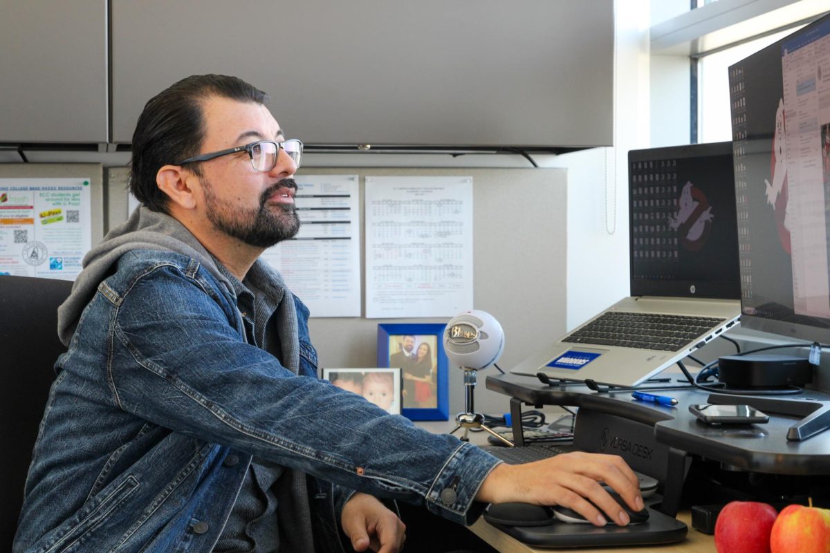 The Assistant Director of Financial Aid David Brown, poses at his desk inside of the Financial Aid Office on Nov. 22. (Kayla Mitchell | The Union)