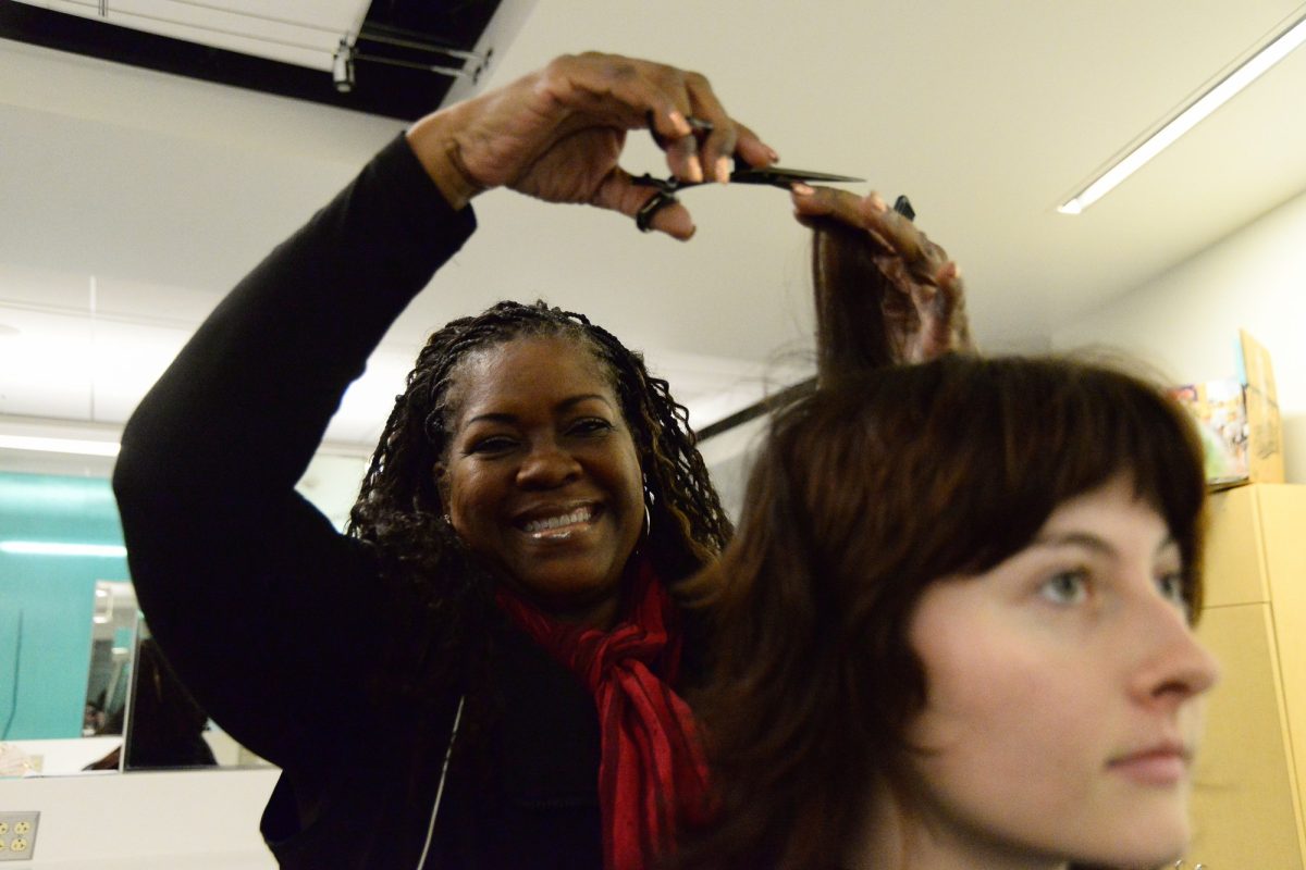 El Camino College Academic Senate President and cosmetology professor Charlene Brewer-Smith demonstrates hair trimming techniques on Lucy Dallavo's hair on Oct. 16. Brewer-Smith has worked at El Camino since 2008.