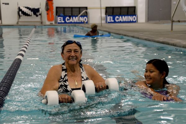 Czarina Go assists Salma Farkouh swim across the shallow pool at the Adapted Pool on Oct. 15, 2024. (Angel Pasillas | Warrior Life)