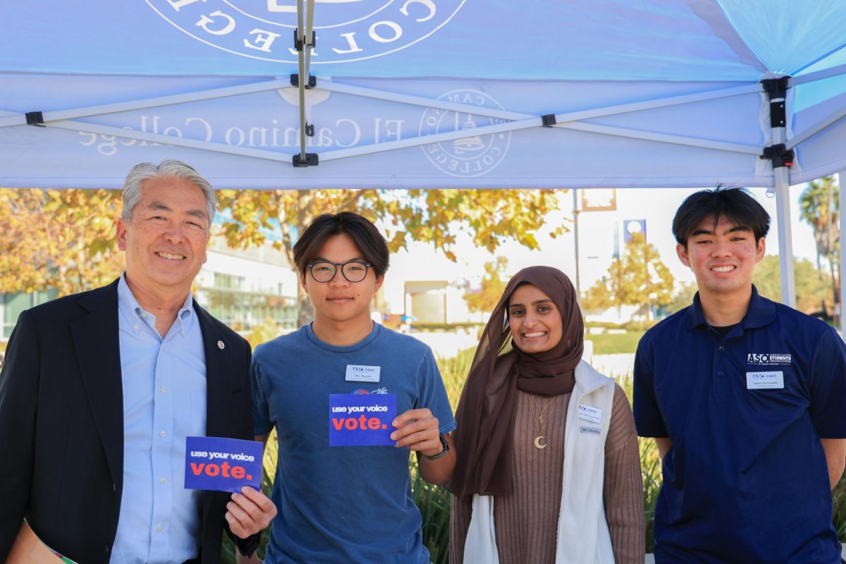 From left, California State Assemblymember Al Muratsuchi visits with Associated Students Organization's Ben Nguyen, director of human resources; Nabeeha Muhammad, director of external affairs; and Jaden Shimazaki, commissioner of finance; at the ASO voter shuttle tent at El Camino College on Monday, Nov. 4, 2024. ECC shuttles were made available to take registered voters to polling places on Monday and Tuesday. Muratsuchi, who represents the 66th Assembly District, is teaching a political science class at ECC this semester. (Elsa Rosales | The Union)