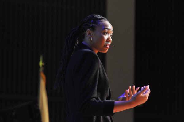 Guest speaker Imani McGee-Stafford practices deep breath exercises with a crowd full of students and staff during "Erasing the Stigma" on Nov. 7 in Marsee Auditorium. (Taheem Lewis | The Union)