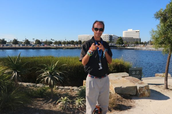 Alex Fleming, 34, outside of the Sofi Stadium posed in front of one of properties lakes.