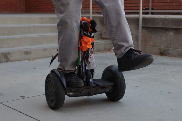 Alex Fleming, 34, rides his beloved Segway, "Tail," outside the Schauerman Library on Sept. 26.