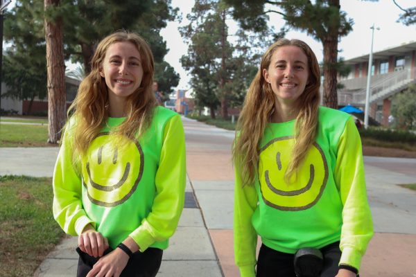 Brooklyn and Brinkley Baker, 19, are all smiles at the Warrior Life launch event at the Library Lawn on Dec. 5, where they rode their unicycles and performed some stunts. (Eddy Cermeno | Warrior Life)