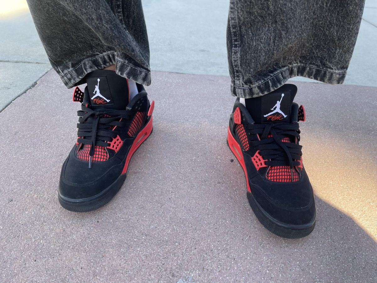 El Camino student Charlie Cazares wears the Air Jordan 4 Retro "Red Thunder" in the Pool and Classroom Complex at El Camino College on Oct. 23. The shoe was released on Jan. 15, 2022 and retailed at $190. It now resells on StockX between $280 to $375.  (Jaylen Morgan | Warrior Life)