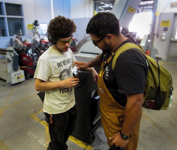 Albert Sandoval helps a student during his welding class on September 30, 2024, at the the Center for Applied Technology (CAT) building | Photo by Chelsea Alvarez