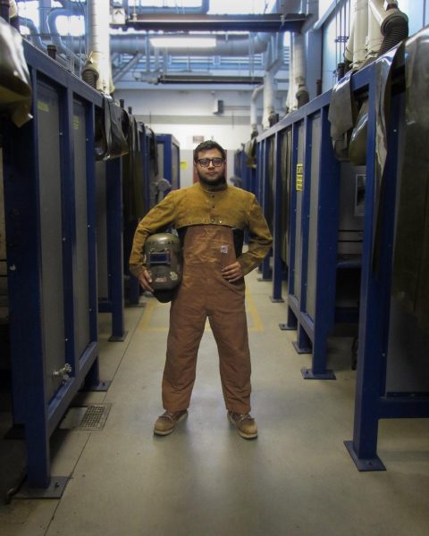 Albert is standing between the welding booth at El Camino Center for Applied Technology (CAT). | Photo by Chelsea Alvarez