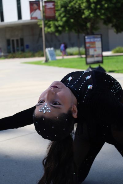 Alahna Alton, pictured here at the Library Lawn at El Camino College on Oct. 3, discovered Latin dance through her salsa club at Redondo Union High School. Since then, Alton has embraced her personality on stage and grown in her confidence, whether it's performing in front of judges or an audience of 5 to 10-year-olds at her workplace. (Angela Osorio | Warrior Life)