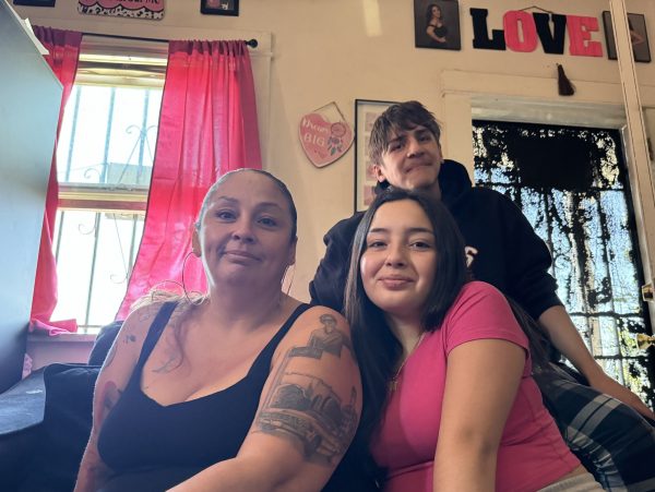 El Camino Guardian Scholar Cassandra Gonzalez (left) with two of her kids - Jonny Orozco, 18 and Elisyannah Valdez, 16 at their home in Inglewood on April 6, 2024. Gonzalez graduates this week with certifications in paralegal studies and real estate. Valdez and Orozco are also graduating from high school. (Kim McGill | Warrior Life)