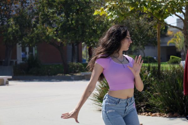 Alahna Alton, 21, dances a basic salsa routine at an El Co Salseros club meeting at the Student Services Plaza on Oct. 1. Alton teaches club members how to dance salsa and bachata every Thursday at 7 p.m. (Angela Osorio | Warrior Life