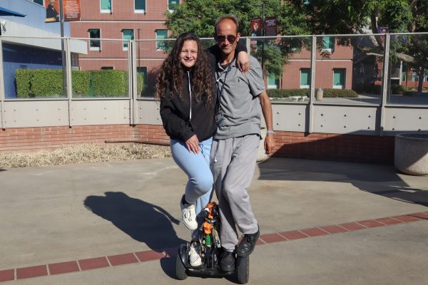 Fleming, 34, Grace, 21, riding Tail the Segway Tandem Style. A trick they learned shortly after becoming friends, outside of El Camino's library