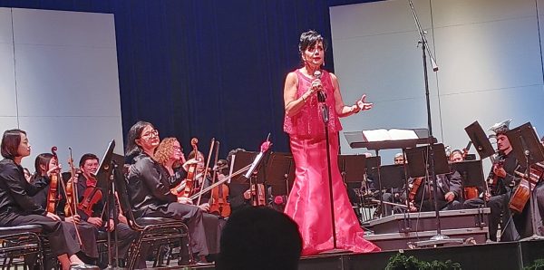 Conductor Dr. Joanna Medawar Nachef gives the audience a history lesson about composer Pyotr Tchaikovsky before performing "The Nutcracker March" at Marsee Auditorium on Tuesday, Dec. 3. (Elliott Bullock II | The Union)