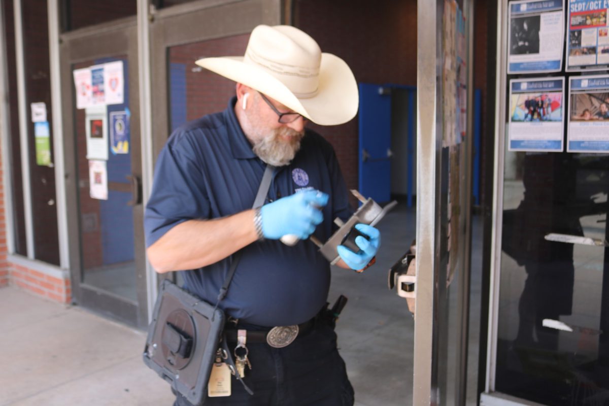 Roy Dietz, 51, begins working on a damaged door of the PE South Building at El Camino College on Sept. 20. Aside from being a locksmith, Dietz serves as president of the classified employees union at El Camino. (Joseph Ramirez | Warrior Life) Photo credit: Joseph Ramirez