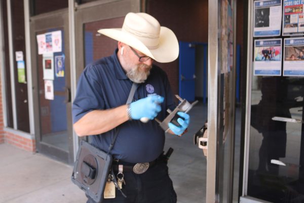 Locksmith Roy Dietz begins working on a damaged door of the PE South Building Sept. 20, 2024. (Joseph Ramirez | Warrior Life)