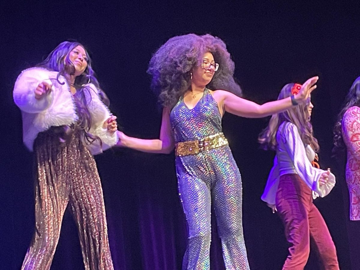 Ashley Labayen, left, and her fellow stylists jam to Donna Summer during their performance as "Disco Diva Dolls" at the 5th annual hair show on Dec. 4. (Erica Lee | The Union)