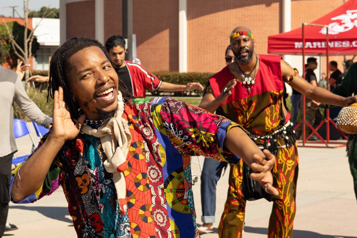 Duante Nabi Fyall performs in the middle of a dance circle in front of the Communications Building on Wednesday, Feb. 26. He is a professor of West African dance at the University of California, San Diego. (Katie Gronenthal | The Union)