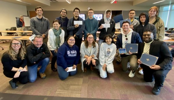 Chuck Bennett (bottom row, second from the left) celebrates with journalism advisors and members of The Union and Warrior Life staff at the journalism department Division Awards in 2022.