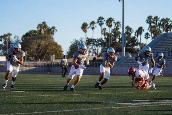 El Camino defensive back Cadence Turner gets the interception and returns it 17 yards to the Santa Barbara 15 yard line while his teammates block at Murdock Stadium on Aug. 30. Turner and the Warriors’ defense held SBCC to only six points and 228 total yards in a dominant victory. (Ryan Hirabayashi | The Union)